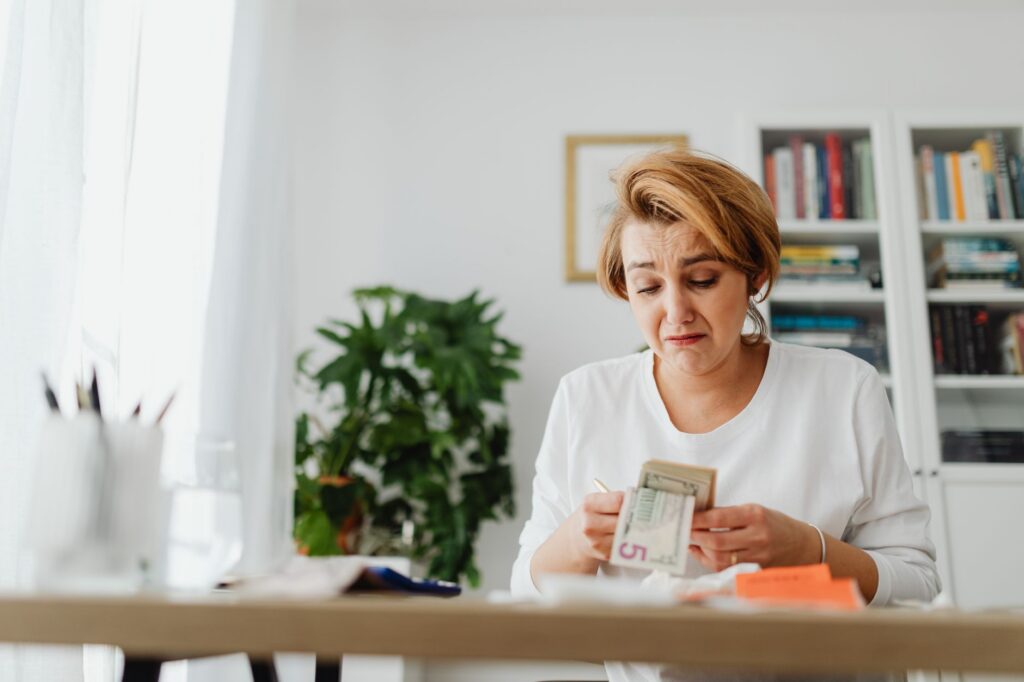 Worried business owner reviewing bills at a desk