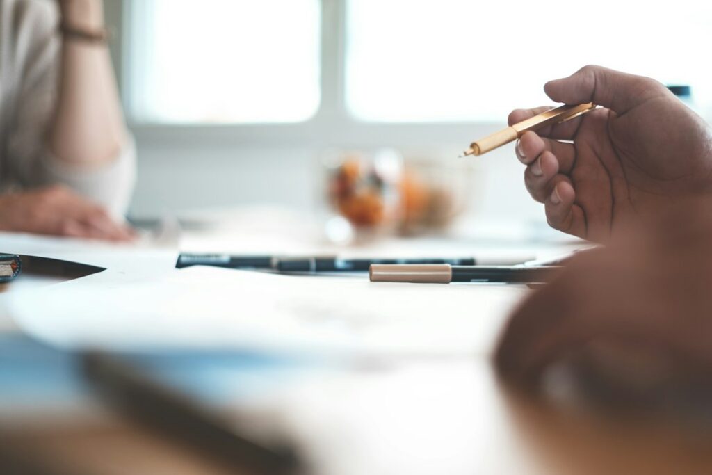 Business owner and specialist negotiating a settlement agreement across a desk