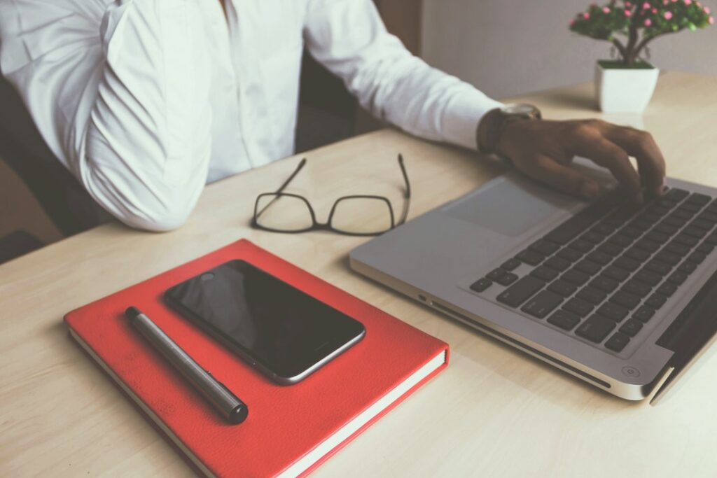 Owner on a phone call at a desk with notes