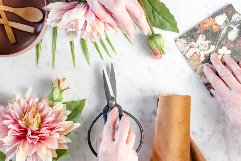 Florist reviewing plans at a workbench among bouquets