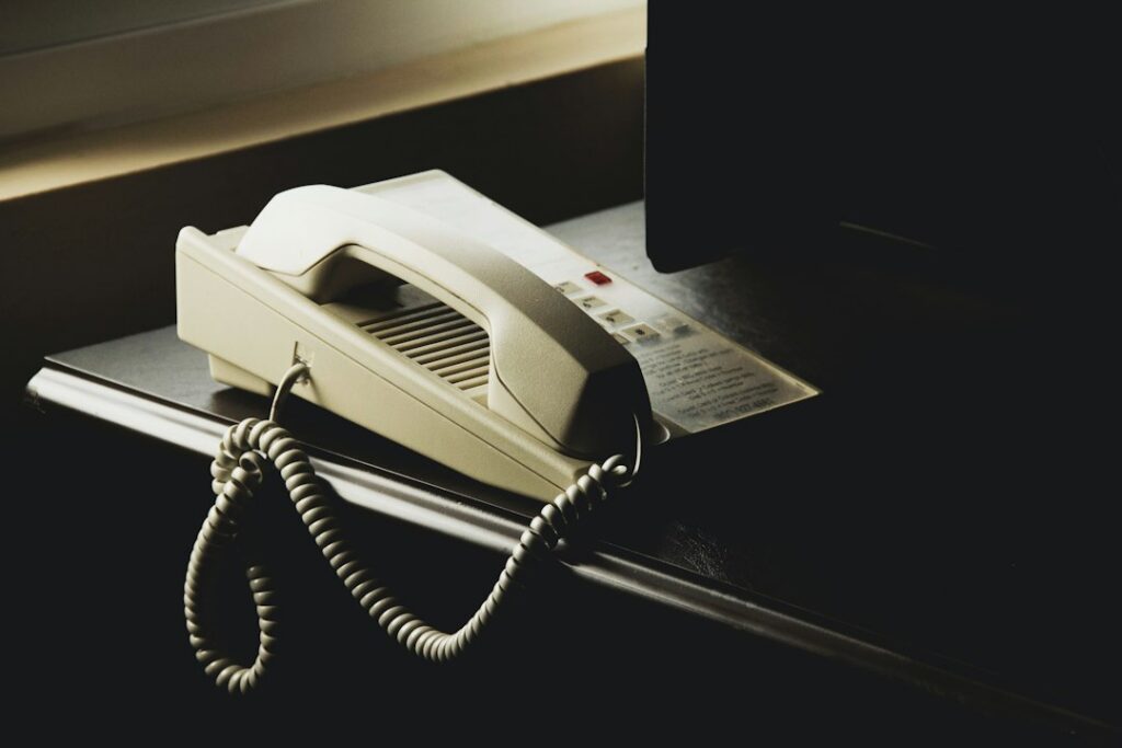 Innkeeper on a phone call at the reception desk