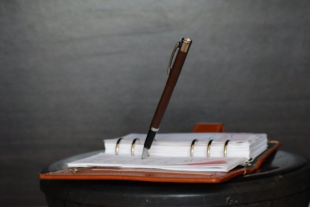 Business documents and a pen on a desk