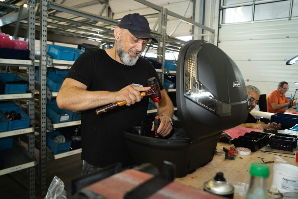Appliance repair technician working inside a washing machine