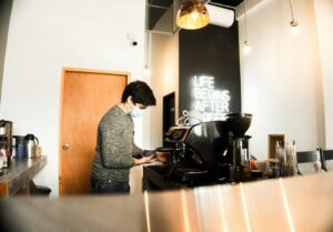 Coffee shop owner reviewing bills and invoices at the counter