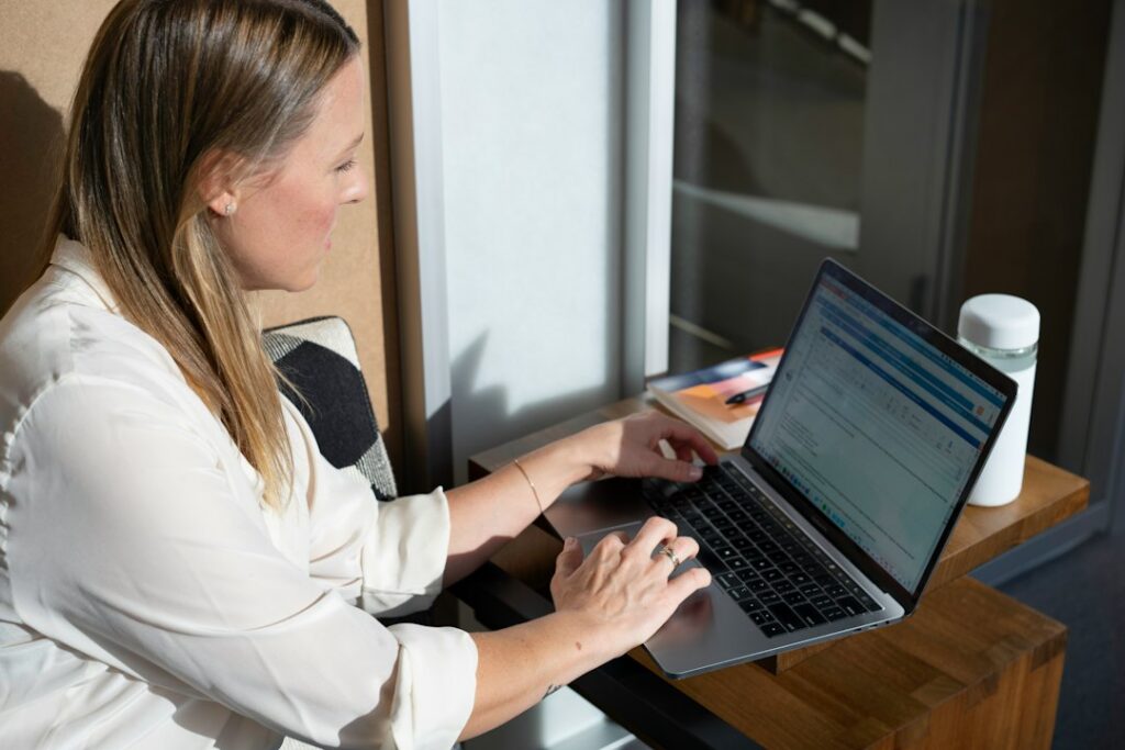 Hotel owner reviewing a bank statement on a laptop at night