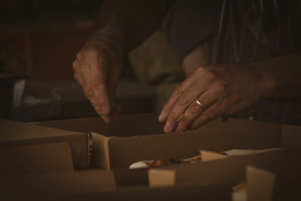 Retail business owner organizing inventory boxes ahead of the holiday season