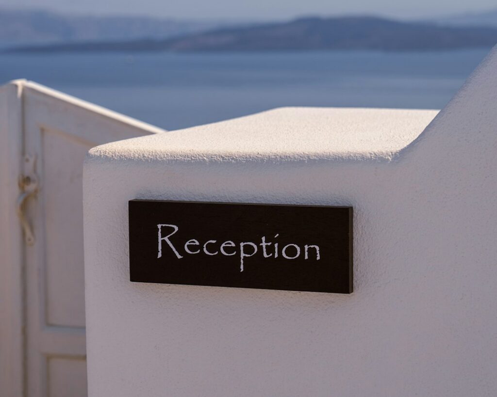 Hotel front desk clerk handing a guest a key card