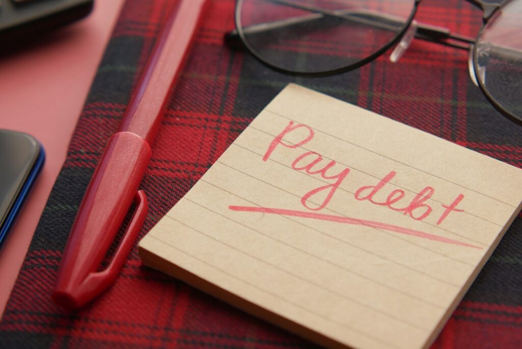 Bank statement and notepad listing weekly payments