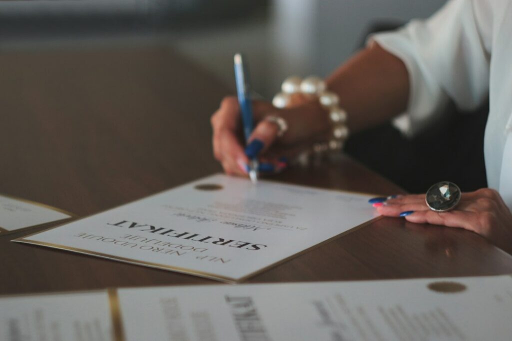Business owner reviewing and signing a settlement agreement at a desk