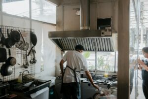 Technician repairing a refrigerator in a home kitchen