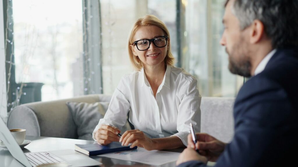 Small business owner meeting with a banker to review bridge financing options