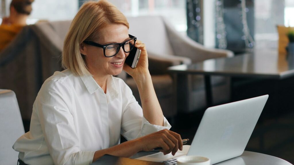Business owner on a phone call discussing account activity with a bank representative