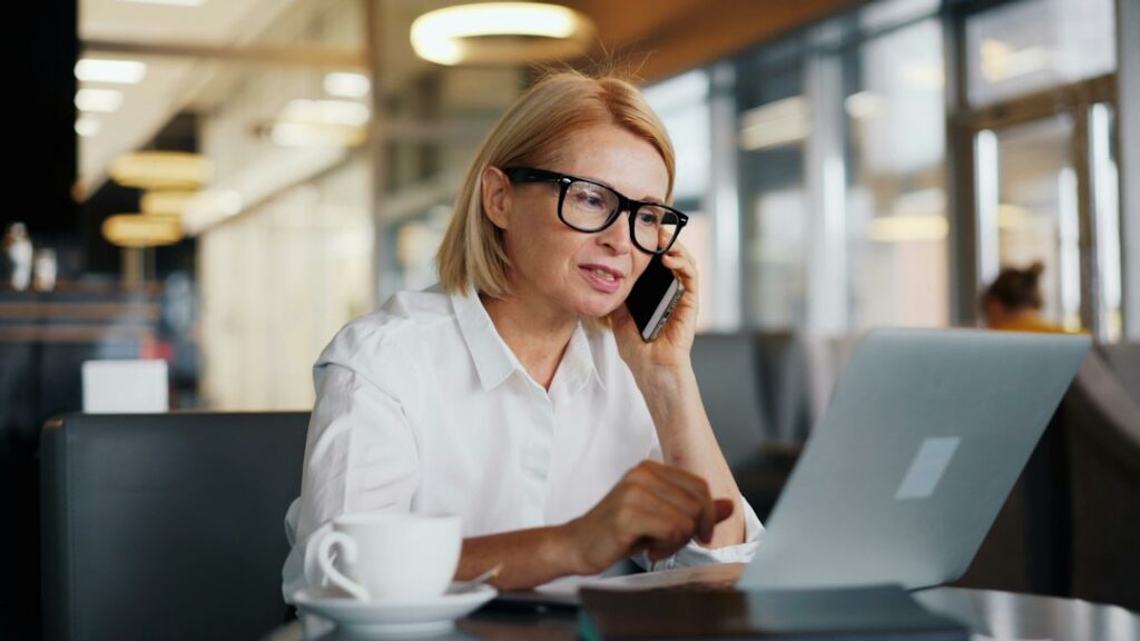 Business owner on a phone call reviewing documents
