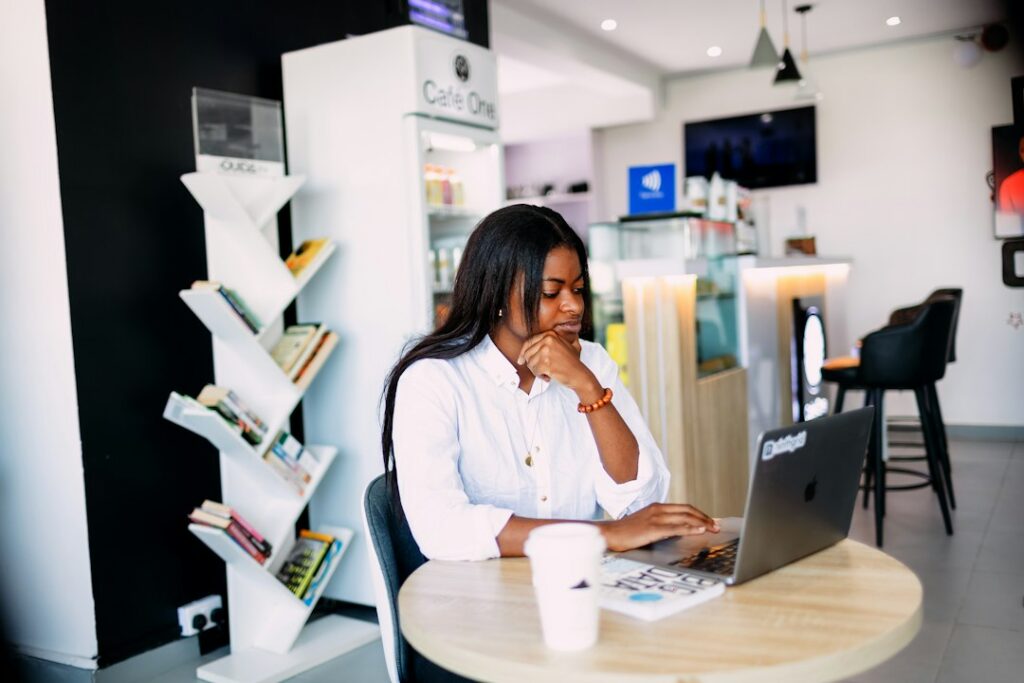 Owner reviewing invoices with a calculator at a shop desk