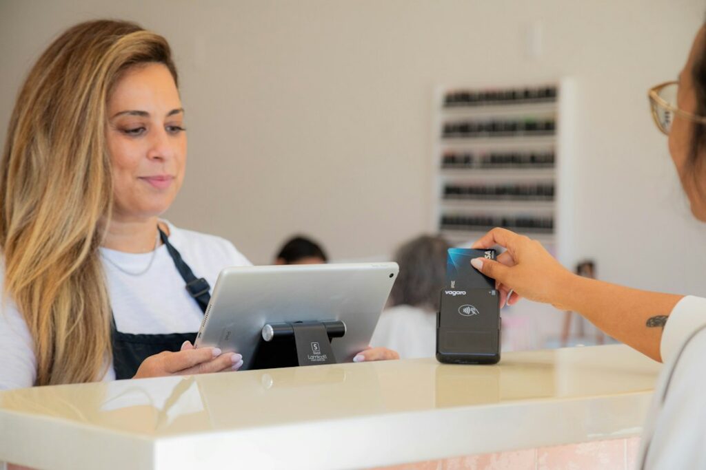 Kennel staff member checking in a dog at a boarding facility front desk