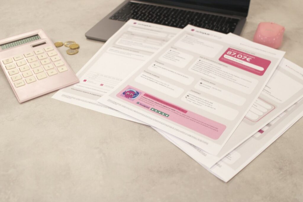 Calculator next to a stack of bills on a small business owner's desk