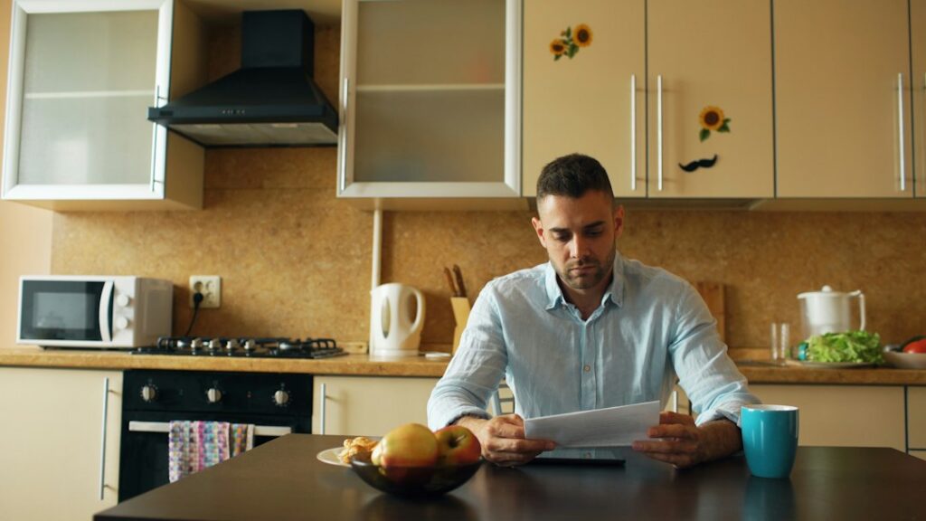 Owner reading a financing offer at a table