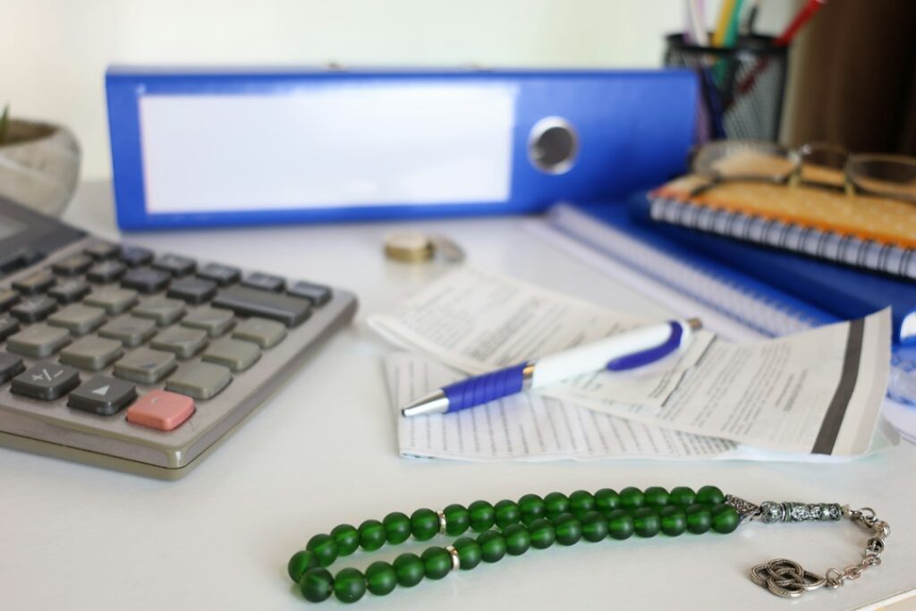 Stack of invoices and a calculator on a desk