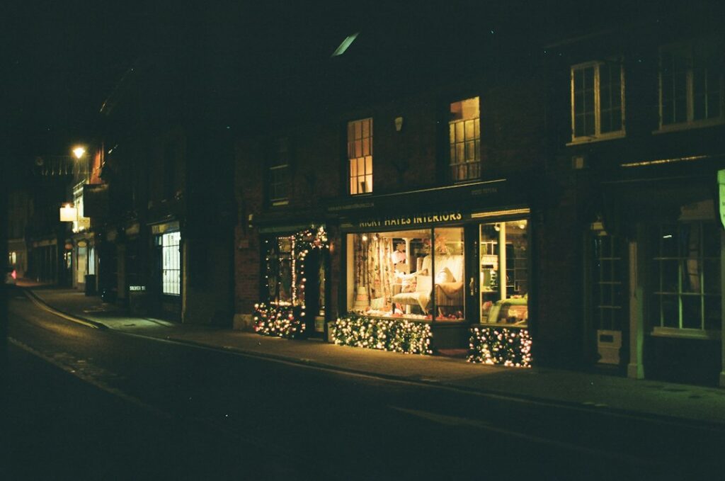 Storefront with holiday lights glowing at night