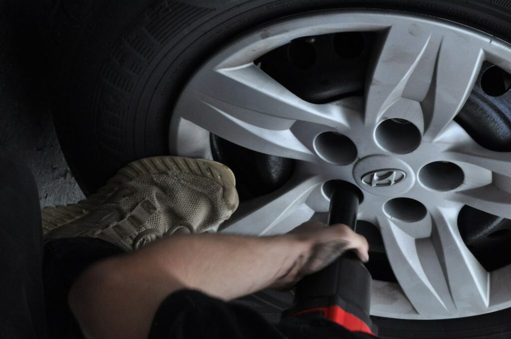 Technician mounting a wheel in a tire shop