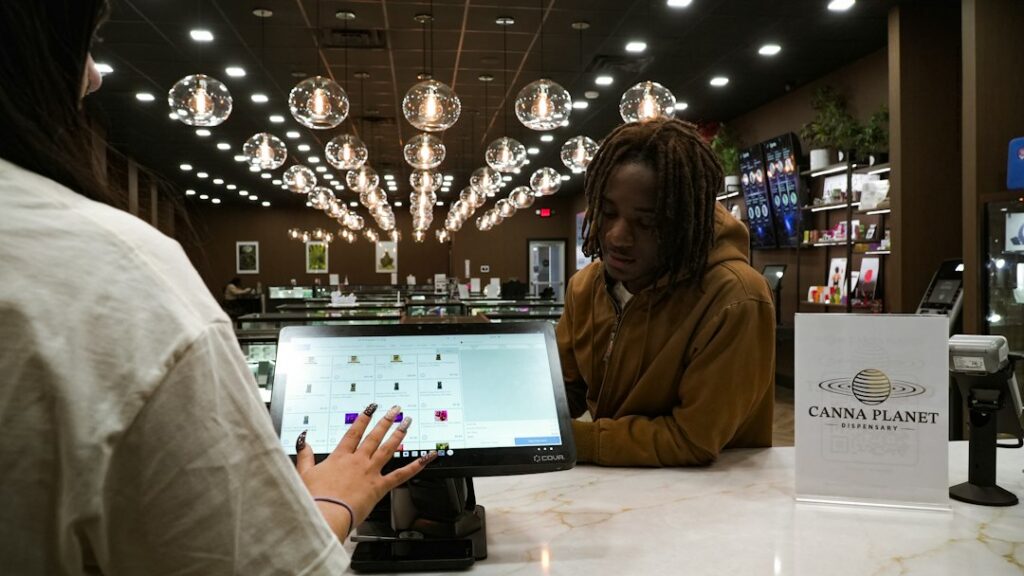 Owner reviewing sales tax paperwork at a shop counter