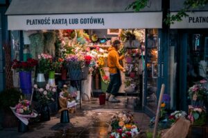 Florist arranging holiday flowers in a small shop