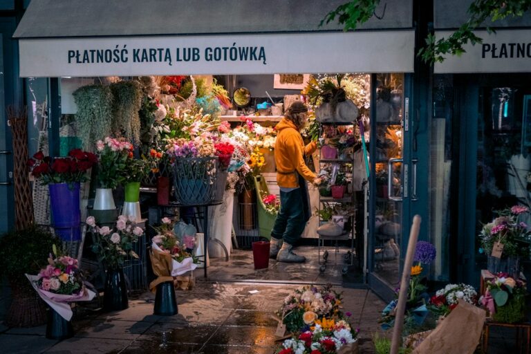 Florist arranging holiday flowers in a small shop