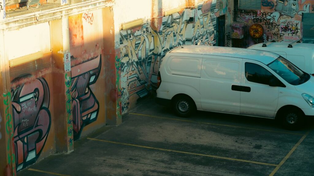Business owner on the phone in front of delivery trucks